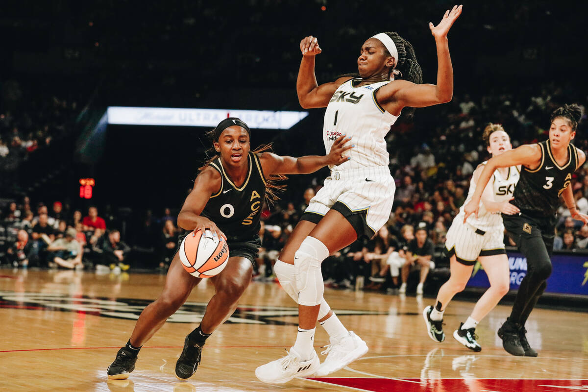 Aces guard Jackie Young (0) pushes Chicago Sky center/forward Elizabeth Williams (1) as she dri ...