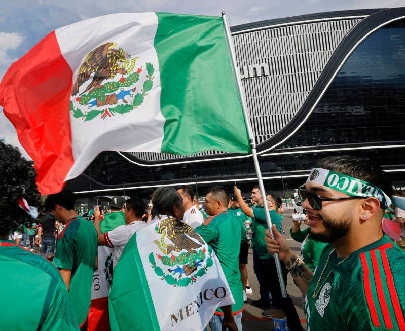 Mexico fan Miguel Angel Munoz of Las Vegas holds a Mexican flag outside the Allegiant Stadium, ...