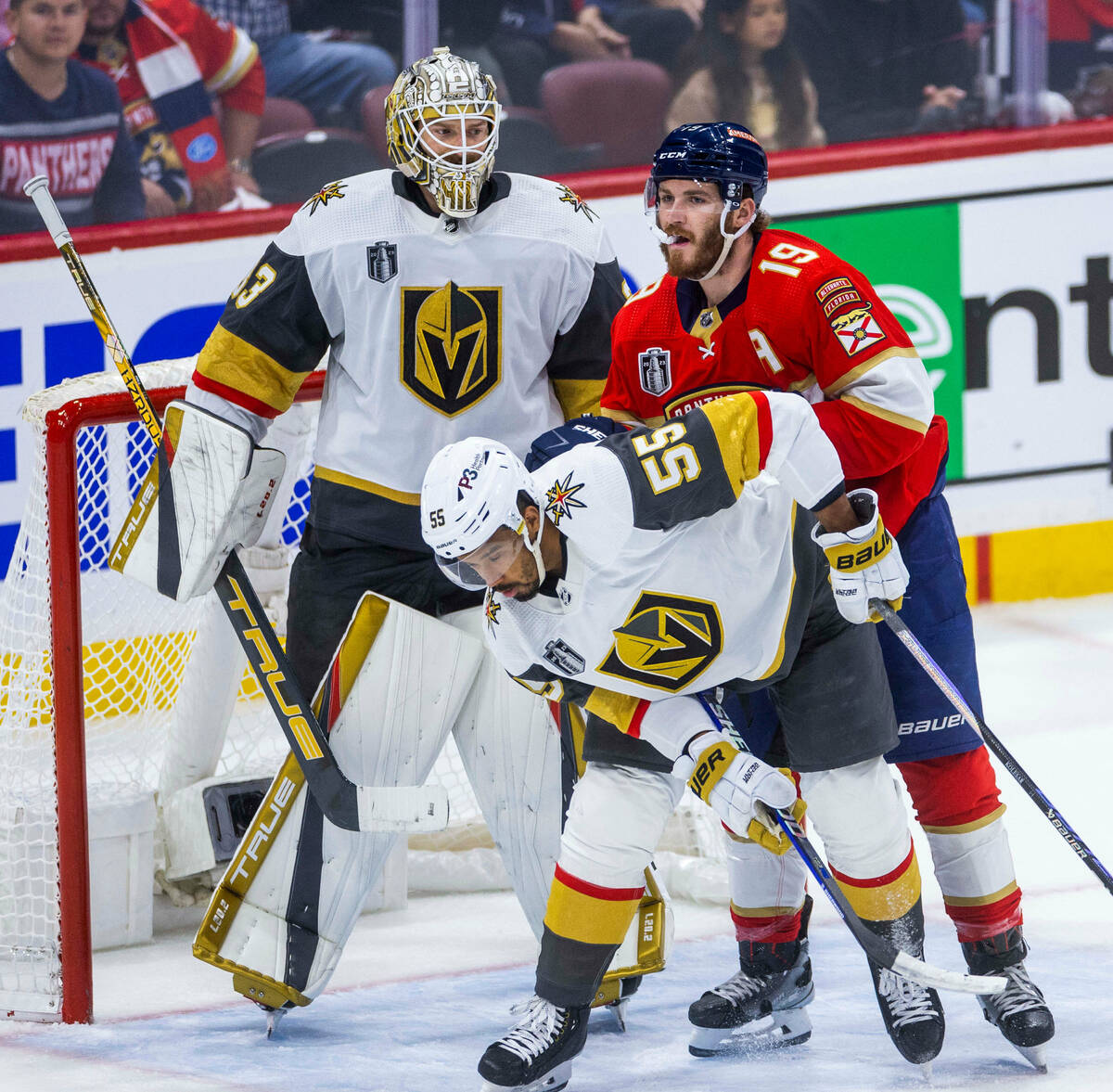 Golden Knights right wing Keegan Kolesar (55) is pushed from behind by Florida Panthers left wi ...