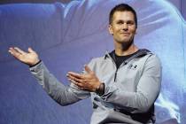 Then-New England Patriots quarterback Tom Brady gestures during a promotional event in Tokyo on ...