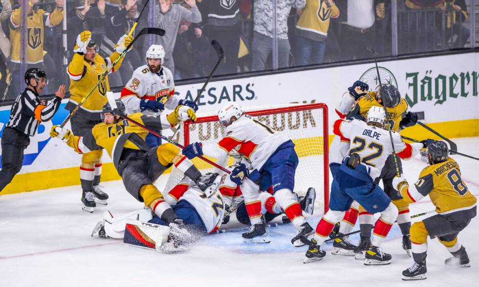 Golden Knights defenseman Nicolas Hague (14) is knocked backwards after scoring on Florida Pant ...