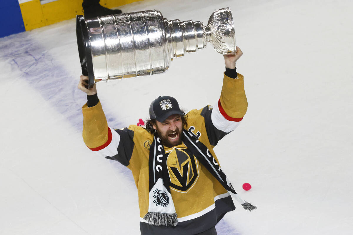 Golden Knights right wing Mark Stone (61) hoists the Stanley Cup after Golden Knights beat Flor ...