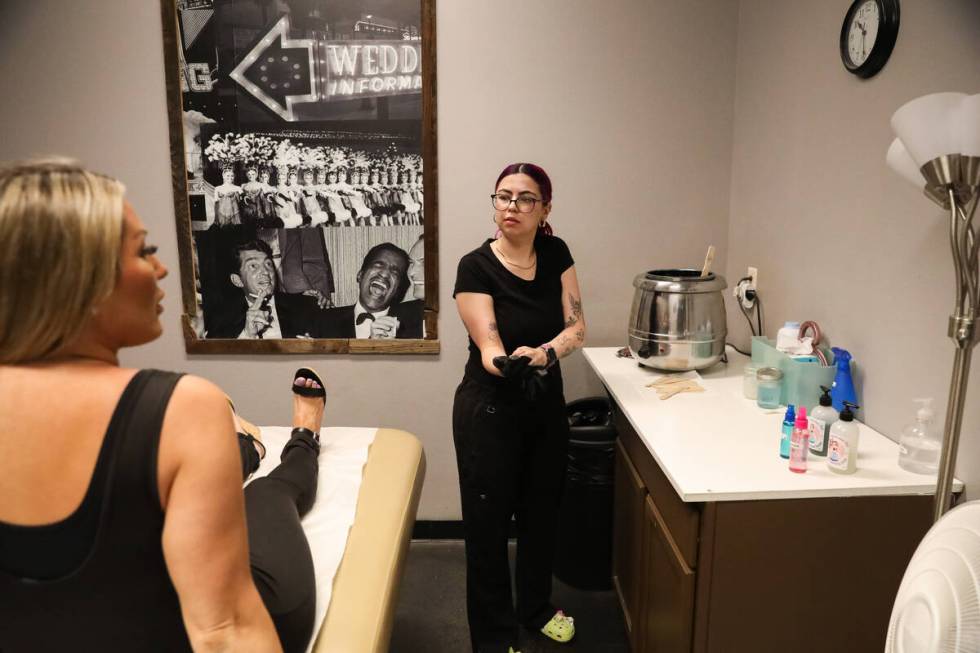 Genevieve Parness, a waxer at The Birthday Suit, prepares to perform a waxing treatment on a cu ...