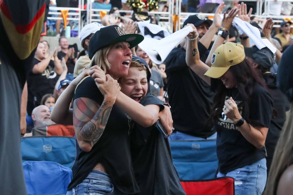 Fans celebrate the Golden Knights winning the Stanley Cup at the Water Street Plaza watch party ...