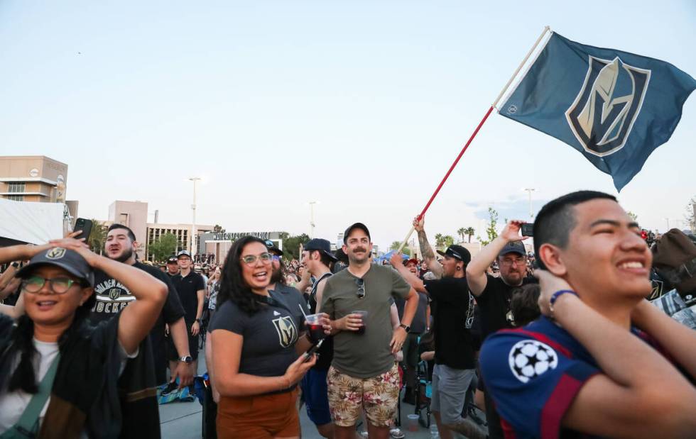 Fans celebrate the Golden Knights winning the Stanley Cup at the Water Street Plaza watch party ...