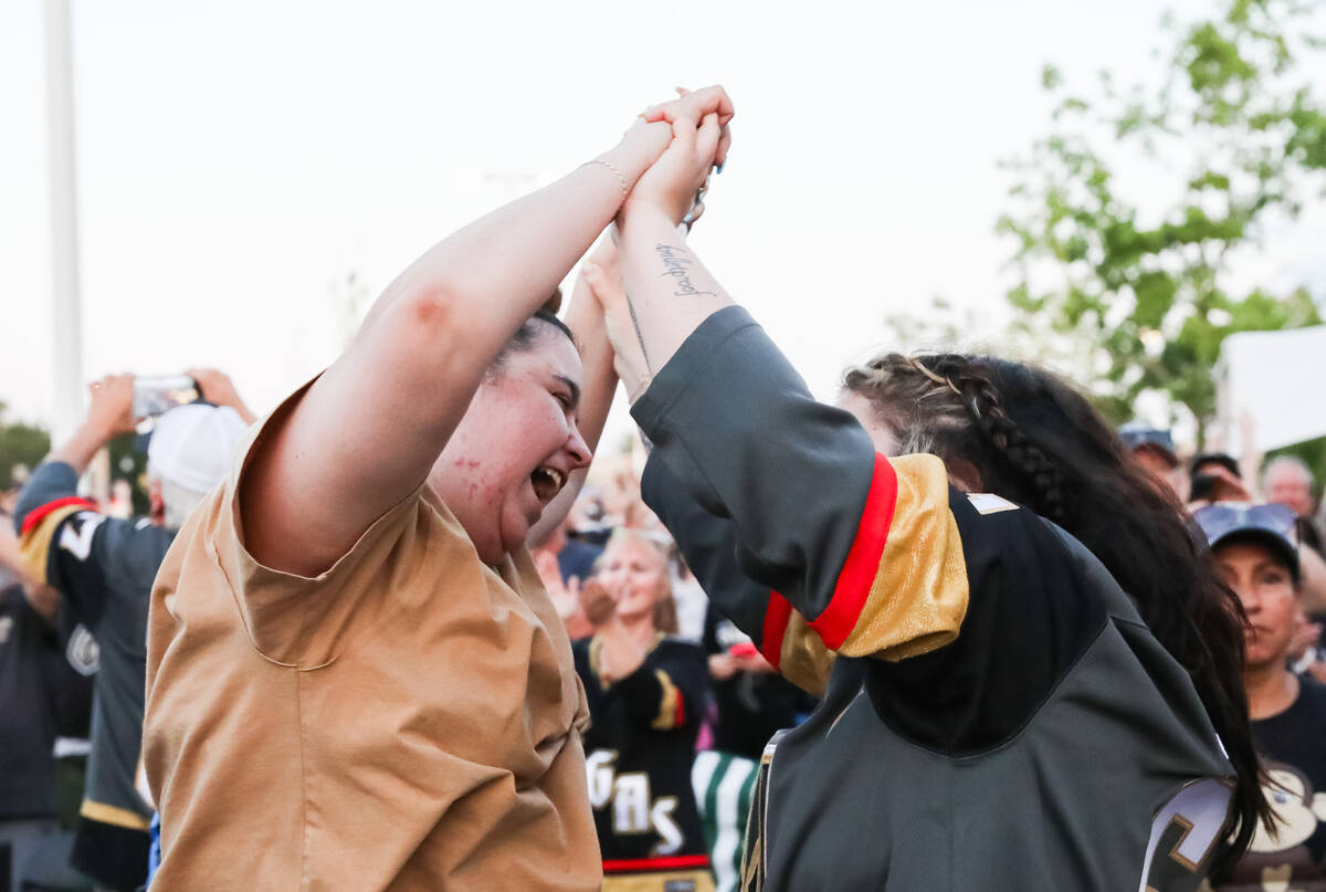 Fans celebrate the Golden Knights winning the Stanley Cup at the Water Street Plaza watch party ...