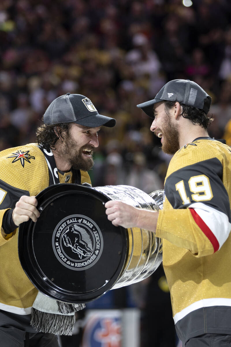Golden Knights captain Mark Stone, left and Reilly Smith, hold the Stanley Cup together after w ...