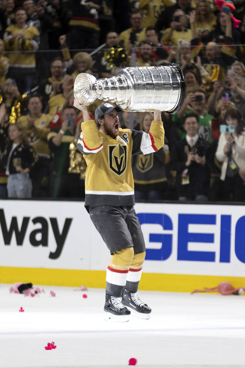 Golden Knights right wing Reilly Smith (19) holds up the Stanley Cup after winning Game 5 of th ...