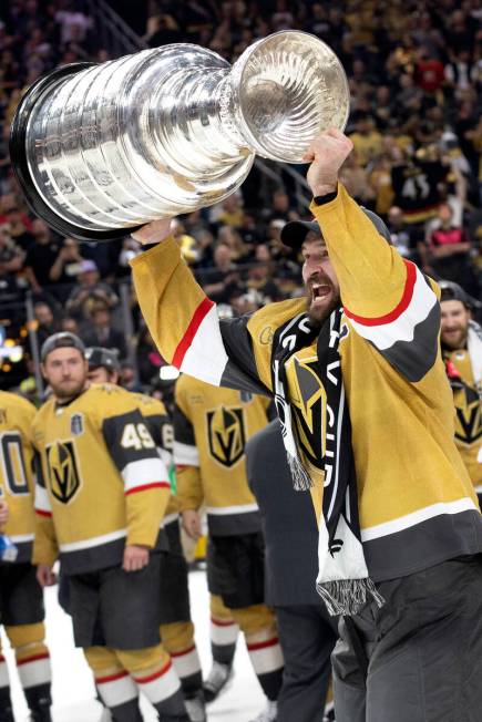 Golden Knights right wing and captain Mark Stone holds up the Stanley Cup after winning Game 5 ...