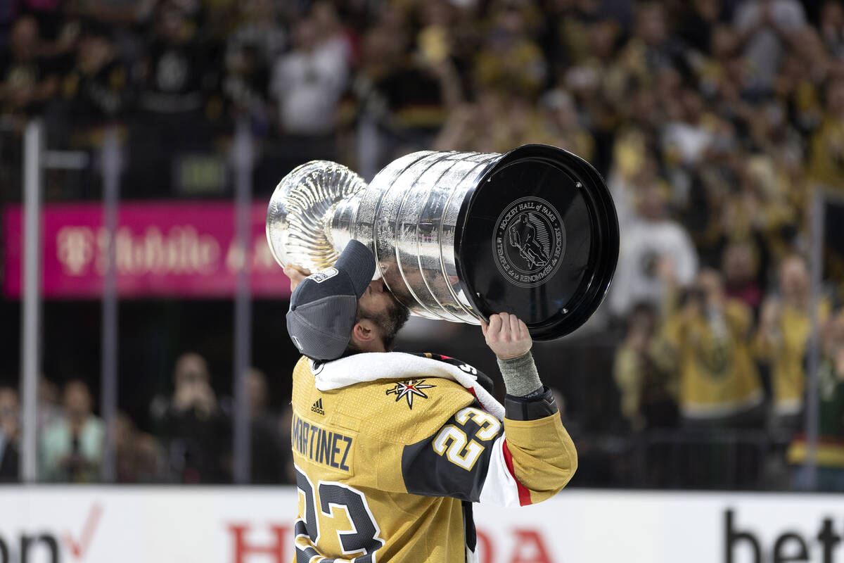 Golden Knights defenseman Alec Martinez (23) kisses the Stanley Cup after his team won the NHL ...