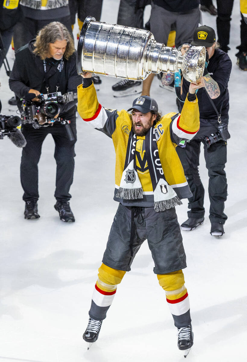 Golden Knights right wing Mark Stone (61) hoists the Stanley Cup after their 9-3 win over the F ...