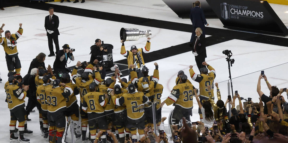 Golden Knights right wing Mark Stone (61) hoists the Stanley Cup after the Knights beat the Flo ...