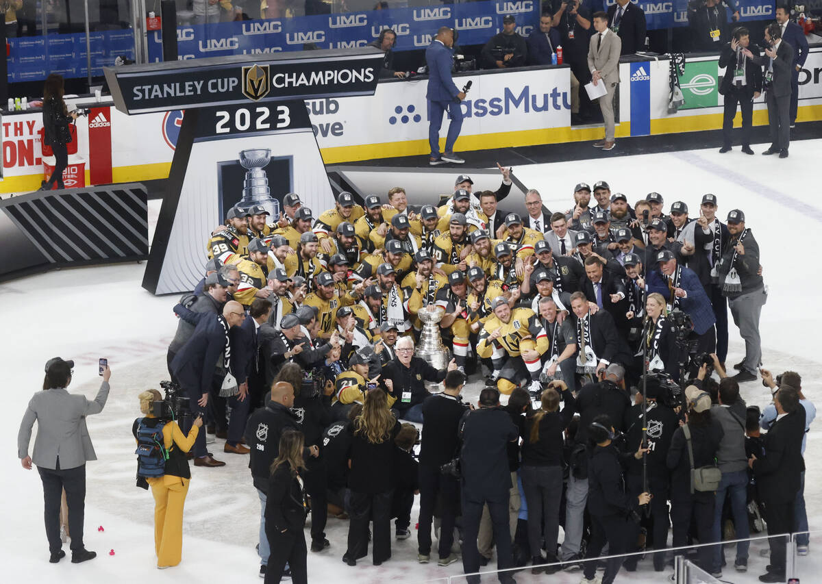 Golden Knights players pose for a photo with the Stanley Cup trophy after their victory against ...