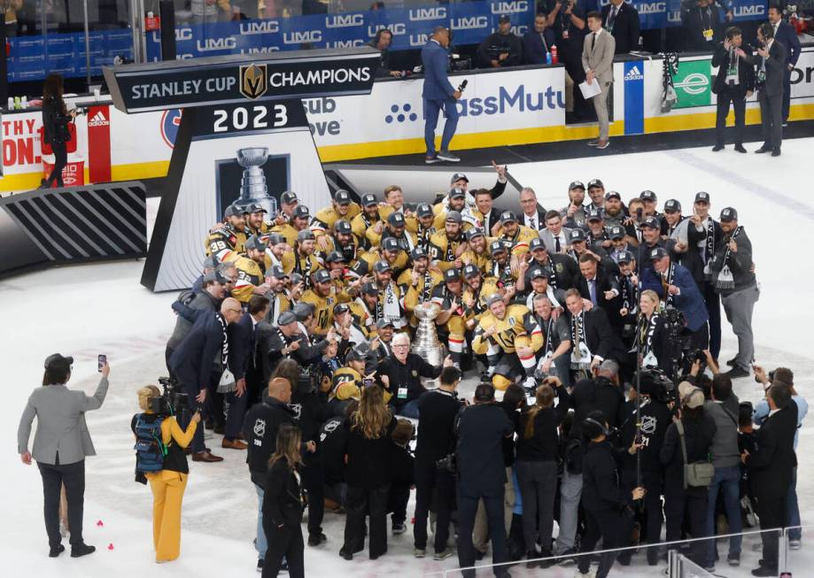 Golden Knights players pose for a photo with the Stanley Cup trophy after their victory against ...