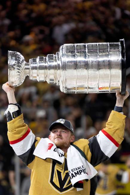 Golden Knights center Jack Eichel holds up the Stanley Cup after winning Game 5 of the NHL hock ...