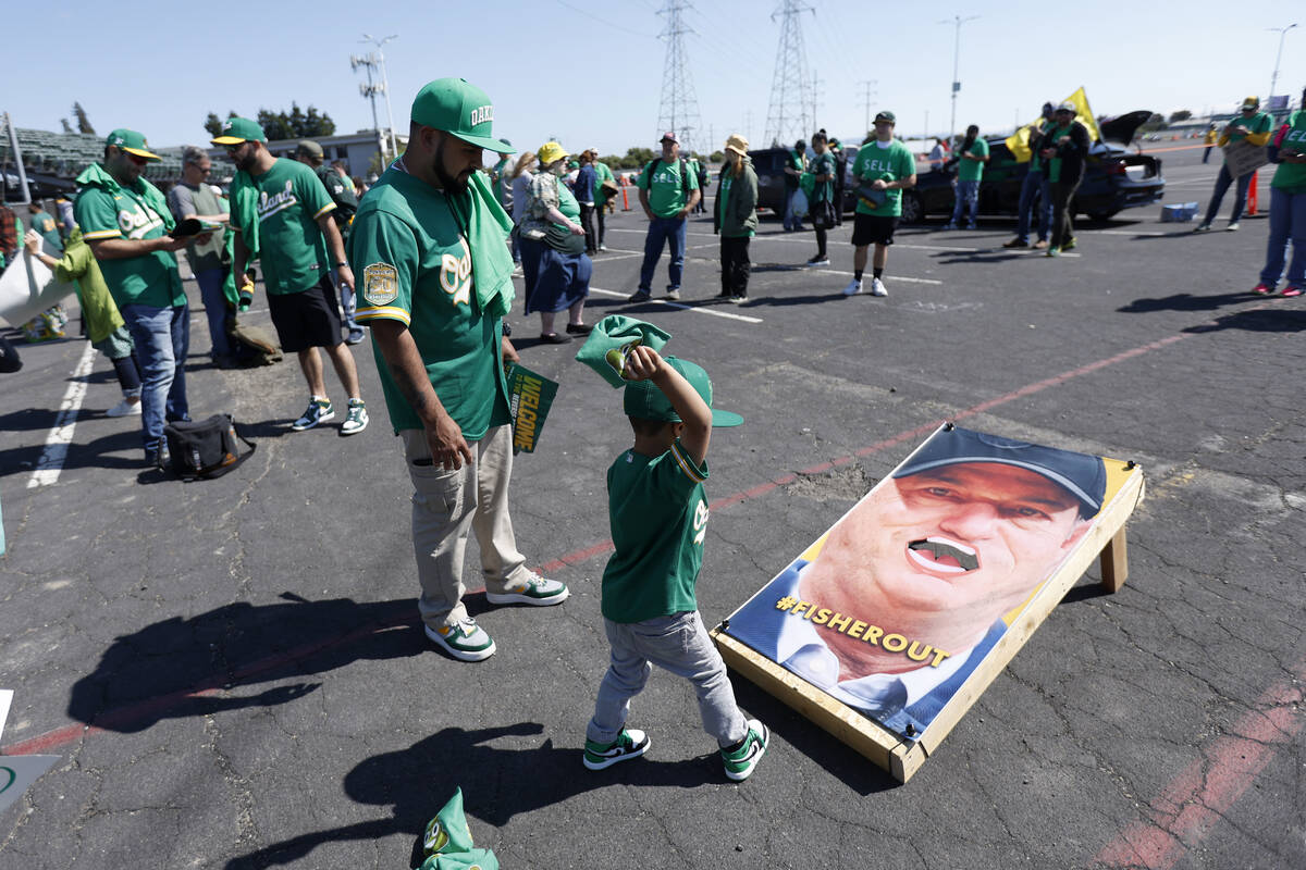 Pepito Mendez, center, plays cornhole with his father, Paco Mendez, of Pittsburg, Calif., outsi ...