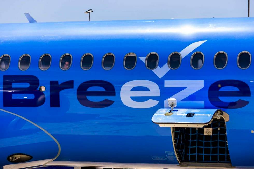 A Breeze Airways passenger looks out the window as their inaugural flight arrival makes it to t ...