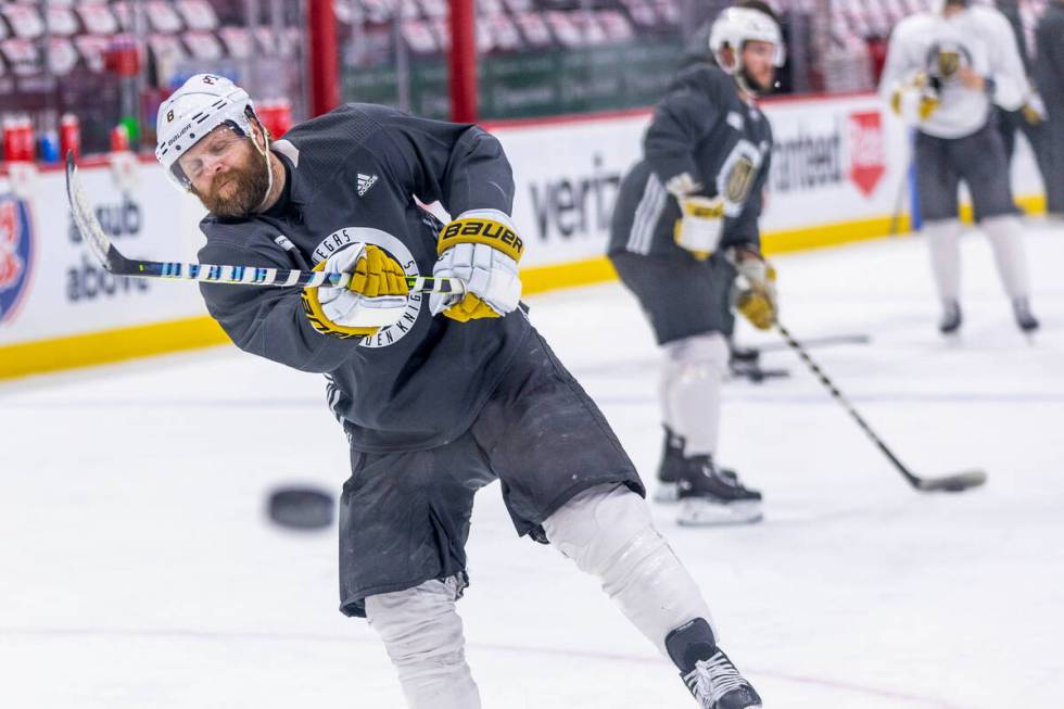 Golden Knights right wing Phil Kessel (8) takes a shot at the net defended by goaltender Adin H ...