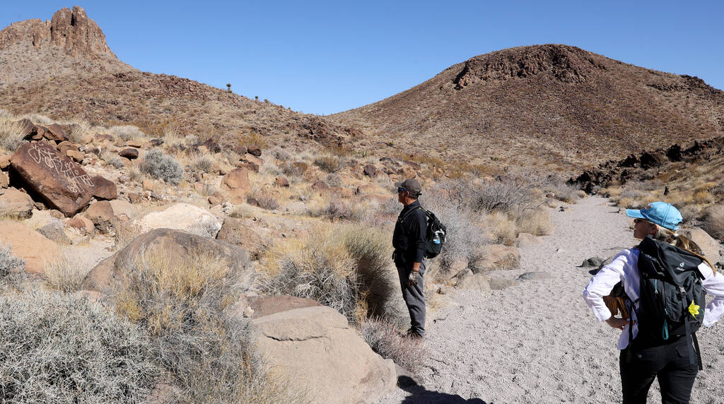 Guido and Wendy Metzger of Henderson check out rock art on the Petroglyph Trail in Sloan Canyon ...