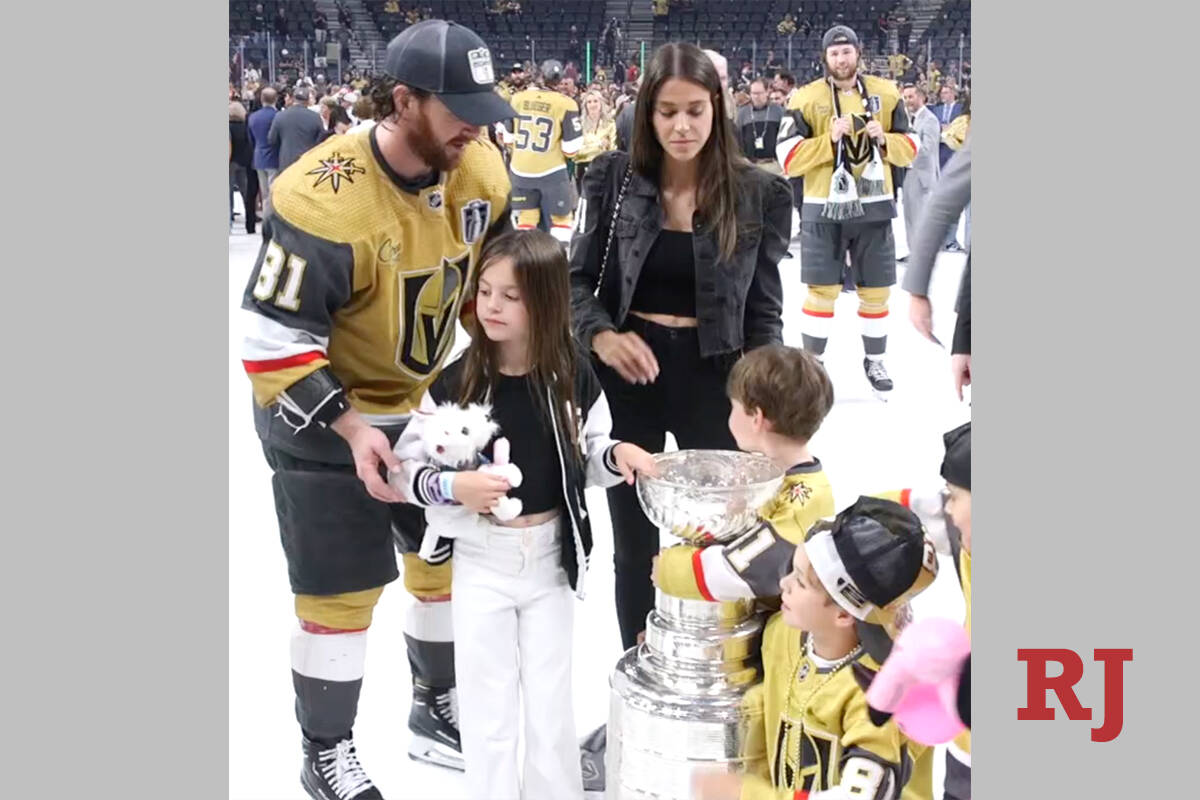 Golden Knights forward Jonathan Marchessault prepares to take a photo of the Stanley Cup with h ...