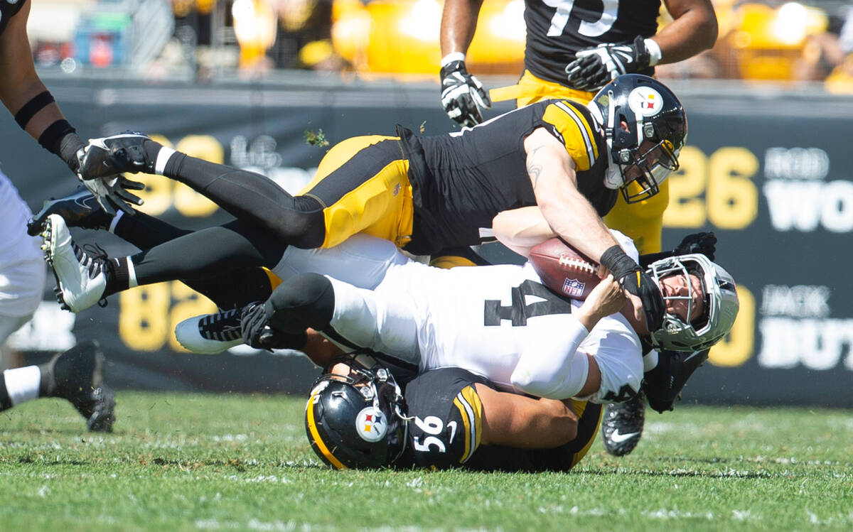 Raiders quarterback Derek Carr (4) is tackled by Pittsburgh Steelers linebacker Robert Spillane ...