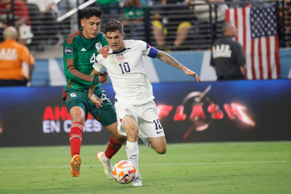 USA’s Christian Pulisic (10) controls the ball against Mexico's Edson Álvarez (4) ...