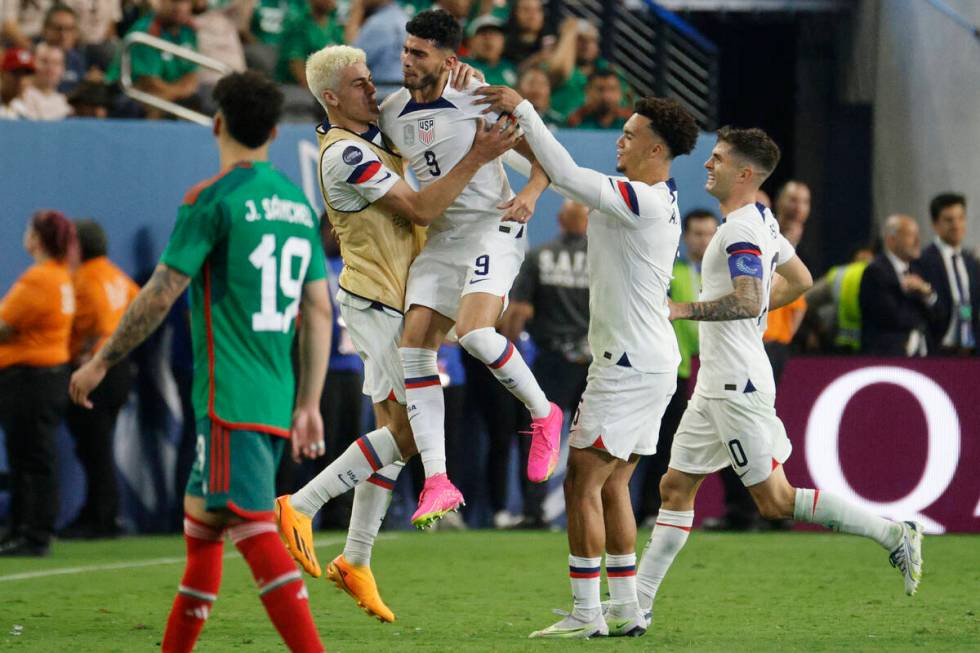 USA’s Ricardo Pepi (9) celebrates with his teammates after he scored a goal against Mexi ...