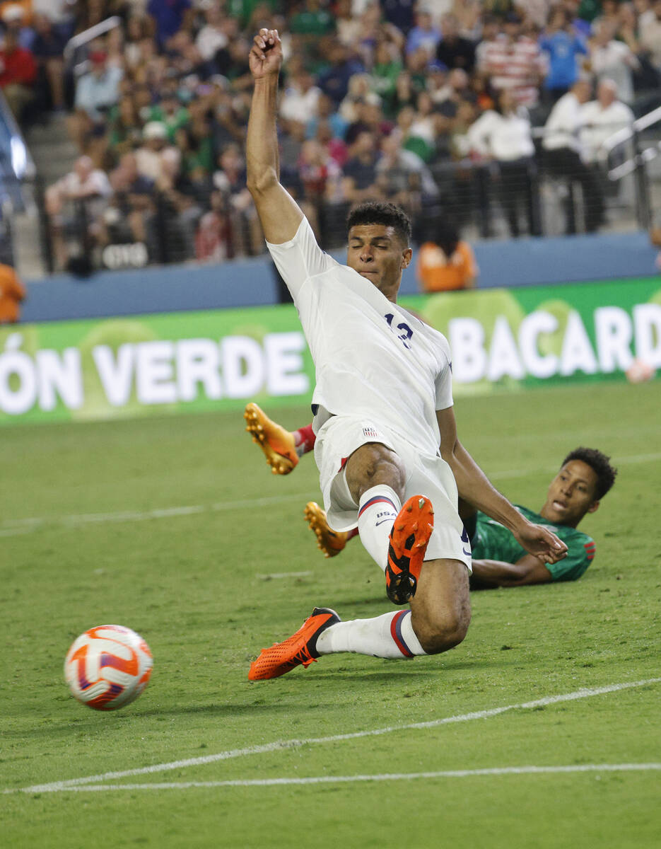 USA’s Miles Robinson (12) gets a ball from Mexico's Ozziel Herrera, behind, during the s ...