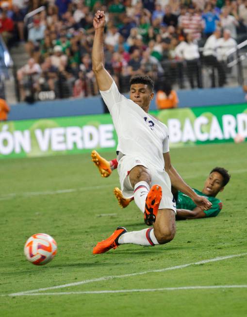 USA’s Miles Robinson (12) gets a ball from Mexico's Ozziel Herrera, behind, during the s ...
