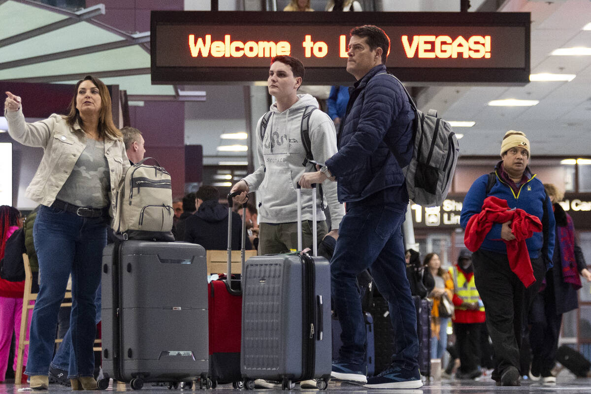 People arrive to the baggage claim area of Terminal 1 at Harry Reid International Airport in La ...