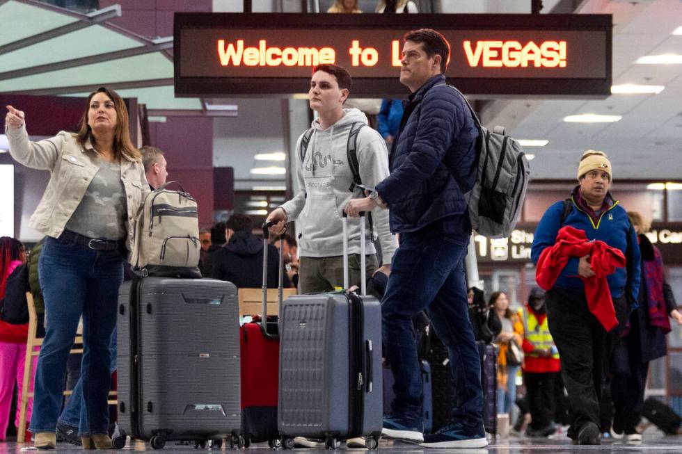 People arrive to the baggage claim area of Terminal 1 at Harry Reid International Airport in La ...