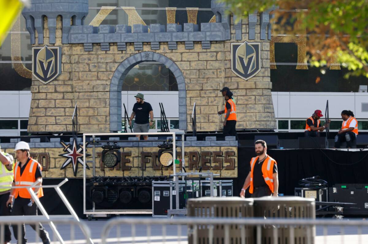 Workers set up the stage for the Stanley Cup victory parade and rally outside T-Mobile Arena on ...