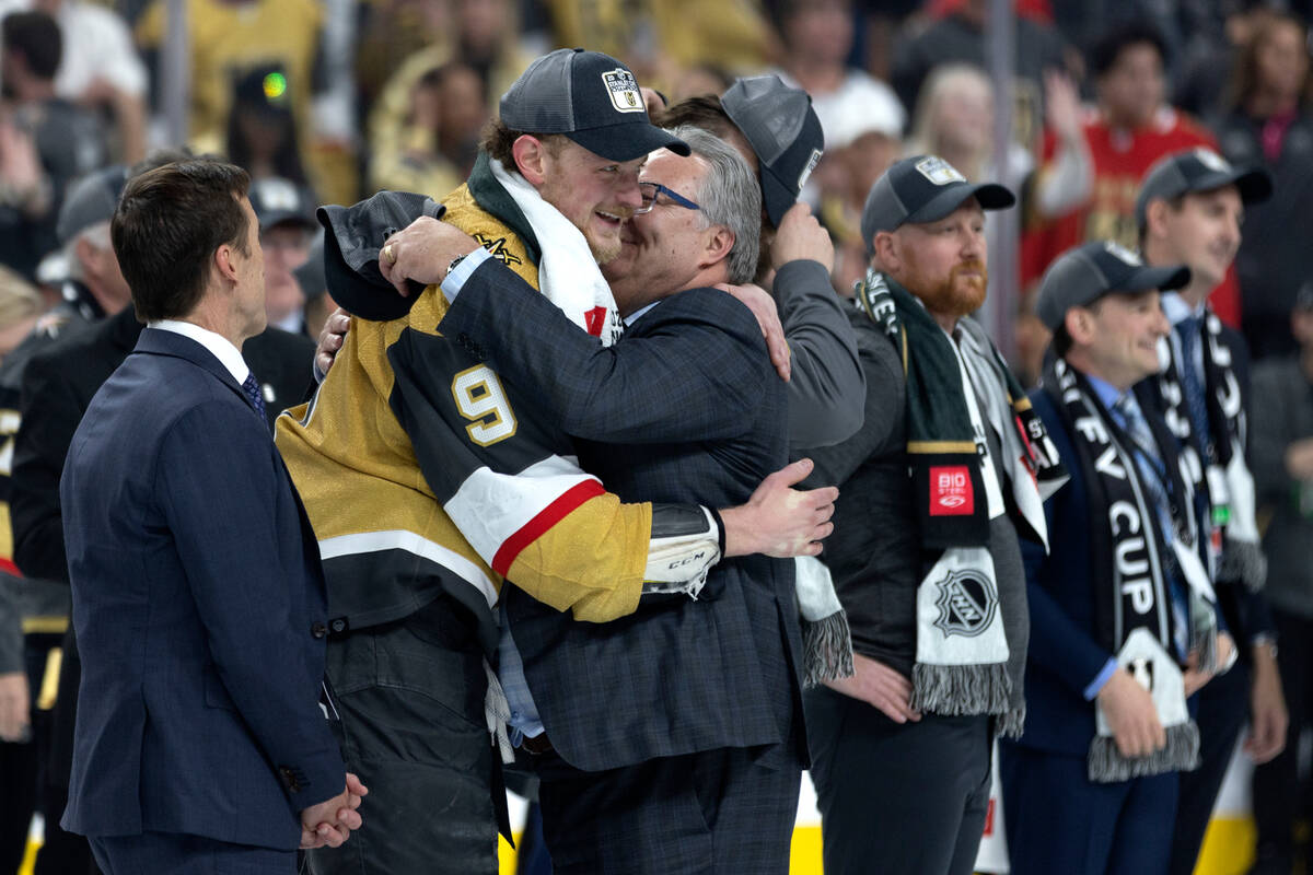 Golden Knights center Jack Eichel hugs Knights’ general manager Kelly McCrimmon after th ...