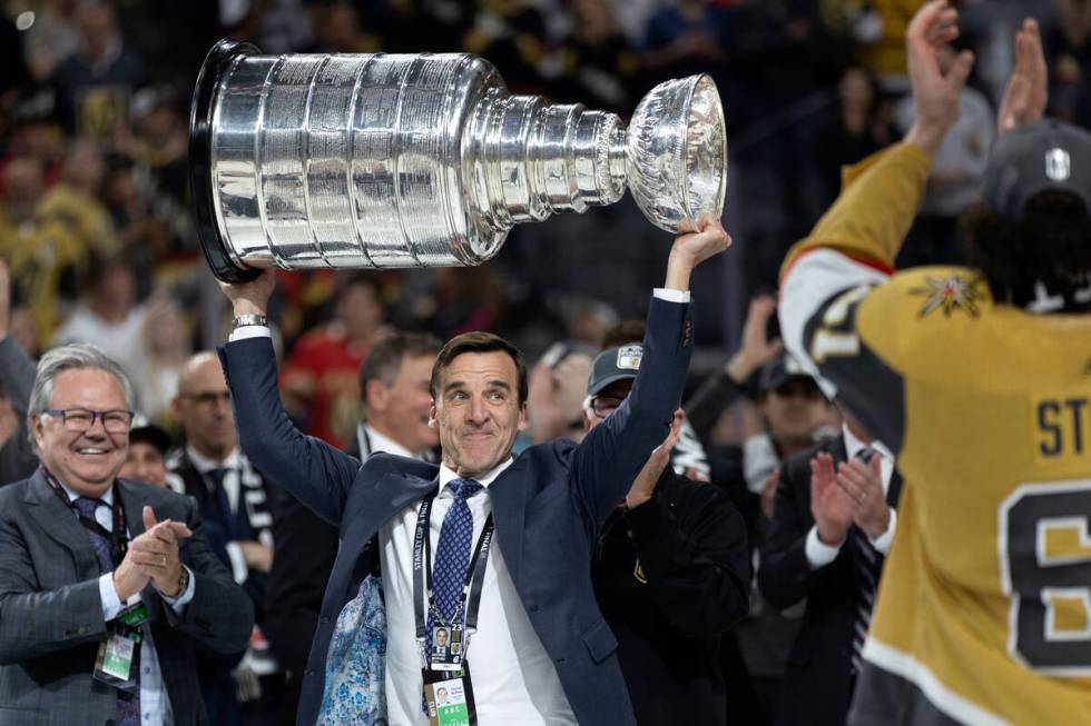 George McPhee, Golden Knights president of hockey operations, hoists the Stanley Cup after the ...