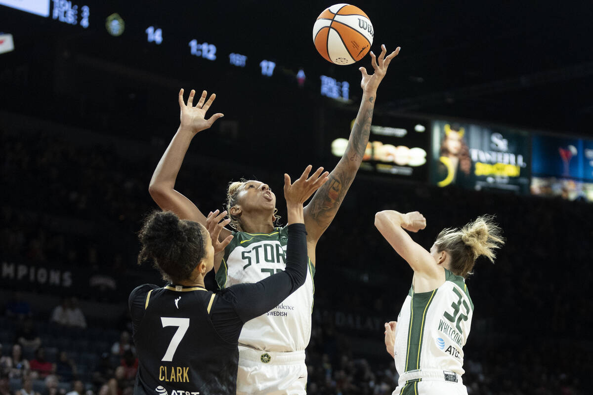 Las Vegas Aces forward Alysha Clark (7) and Seattle Storm center Mercedes Russell (21) jump for ...