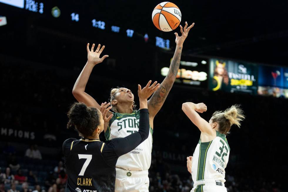 Las Vegas Aces forward Alysha Clark (7) and Seattle Storm center Mercedes Russell (21) jump for ...