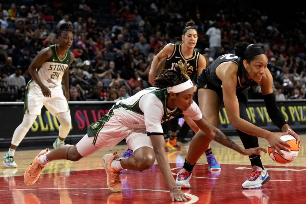 Las Vegas Aces forward A'ja Wilson (22) steals possession from Seattle Storm guard Yvonne Turne ...