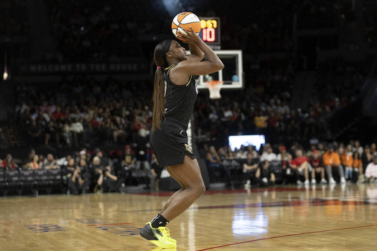 Las Vegas Aces guard Jackie Young (0) bends to shoot before scoring a three-pointer during the ...