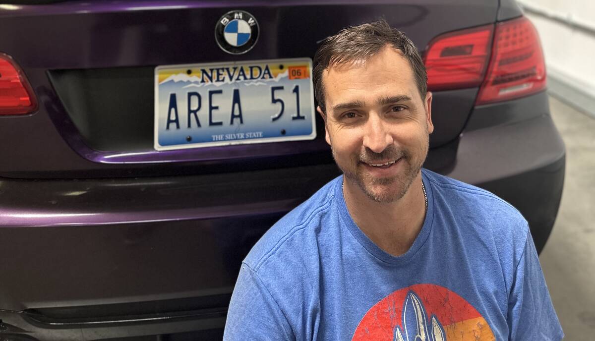 Christopher Sandoval in front of his "AREA 51" vanity Nevada license plate which has spurred ov ...