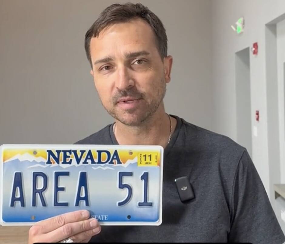 Reno resident Christopher Sandoval holding his "AREA 51" vanity Nevada license plate which has ...