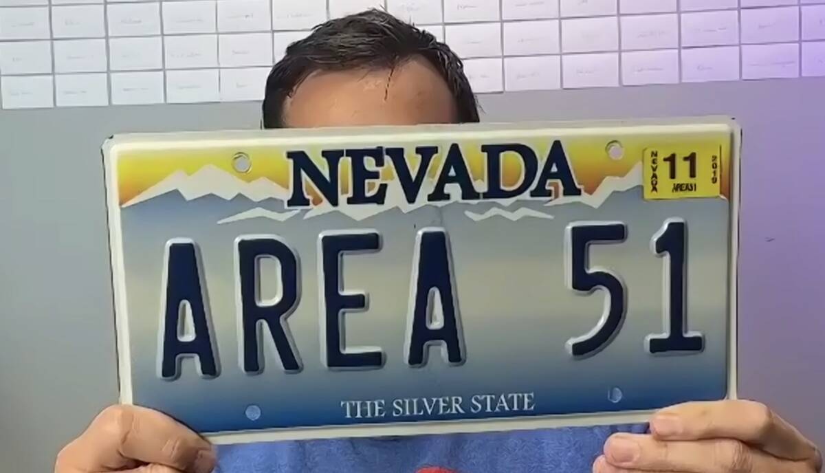 Christopher Sandoval holds his "AREA 51" vanity Nevada license plate which has spurred over 300 ...