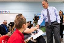 Gov. Joe Lombardo shakes hands with students at Mountain View Christian School and their parent ...