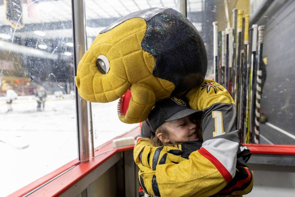 Annabelle Hanson of Janesville, Calif,, 8, hugs Chance, the Golden Knights mascot, at City Nati ...