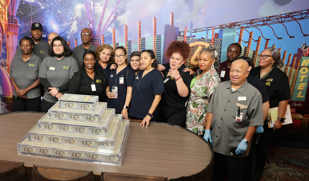 Employees pose with the new Million Dollar Display at Binion's in downtown Las Vegas Friday, Ju ...