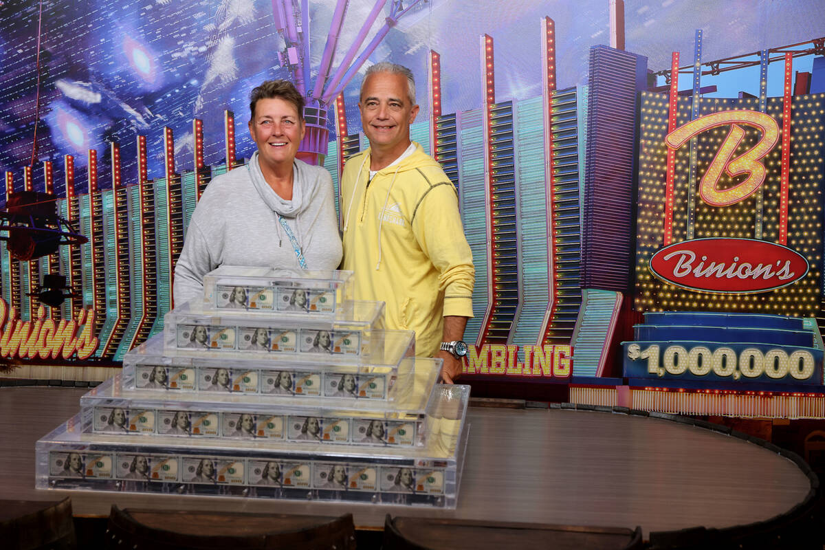 Ron and Jenn Gosciniak of Las Vegas pose with the new Million Dollar Display at Binion's in dow ...