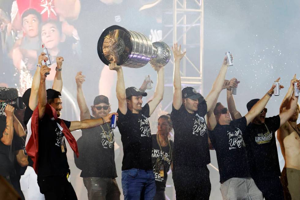 Golden Knights right wing Mark Stone, center, hoists the Stanley Cup with his teammates during ...