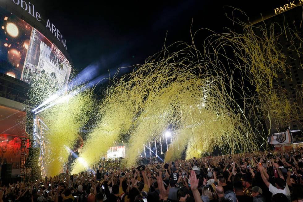 People celebrate during a rally at Toshiba Plaza after the Golden Knights’ NHL hockey St ...