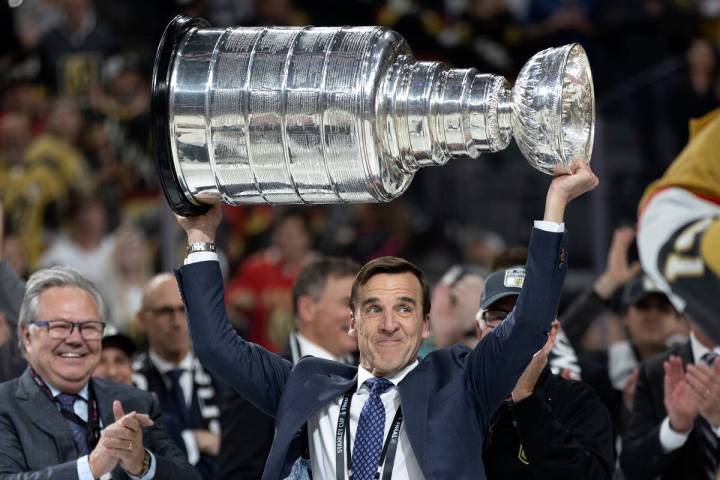 George McPhee, Golden Knights president of hockey operations, hoists the Stanley Cup after the ...