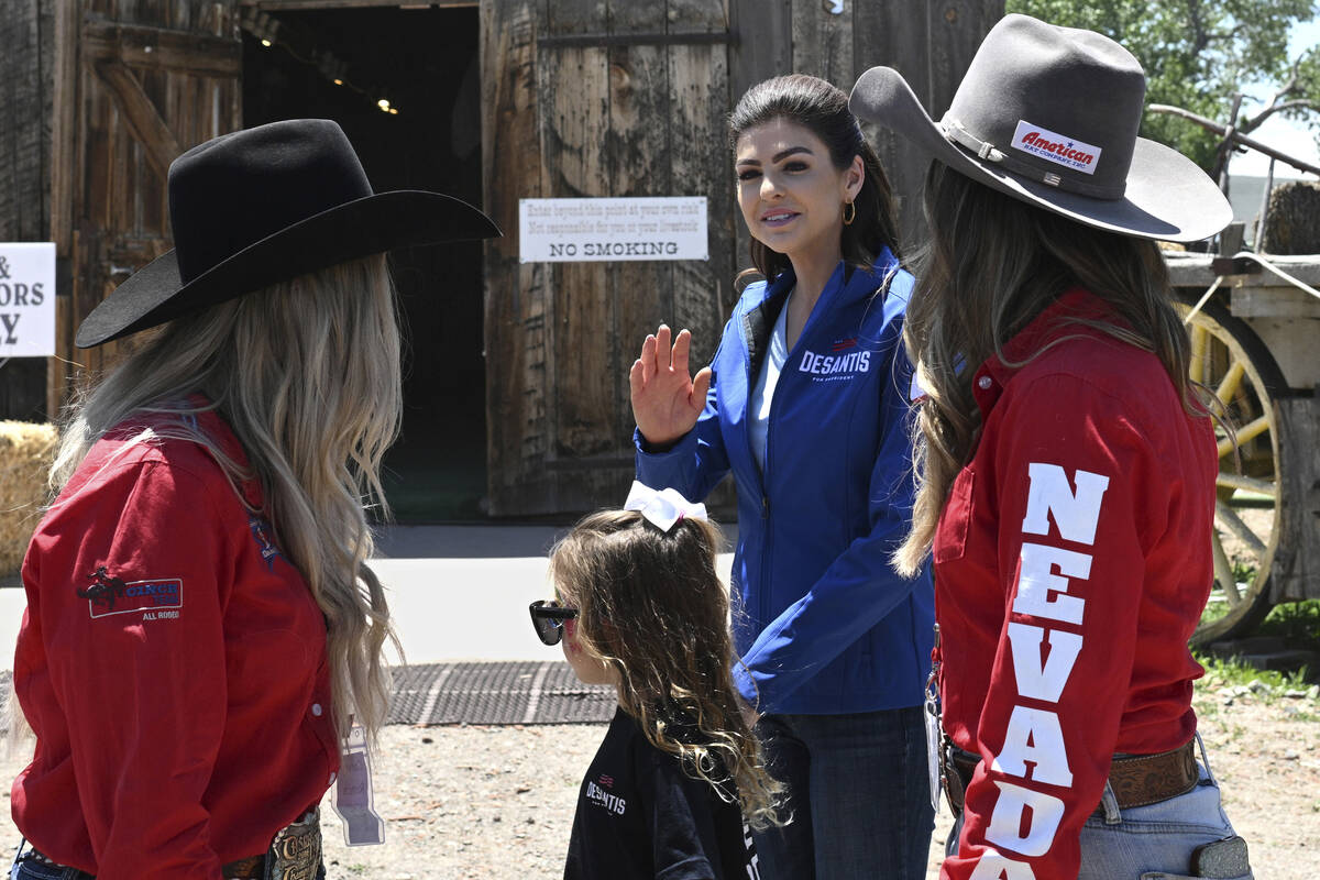 Florida Gov. Ron DeSantis' wife Casey DeSantis, with daughter Madison, 7, waves at a supporter ...