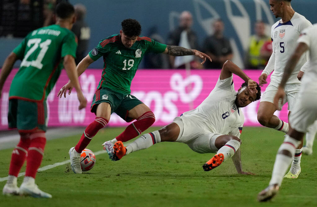 Jorge Sanchez of Mexico, left, and Weston McKennie of the United States battle for the ball dur ...
